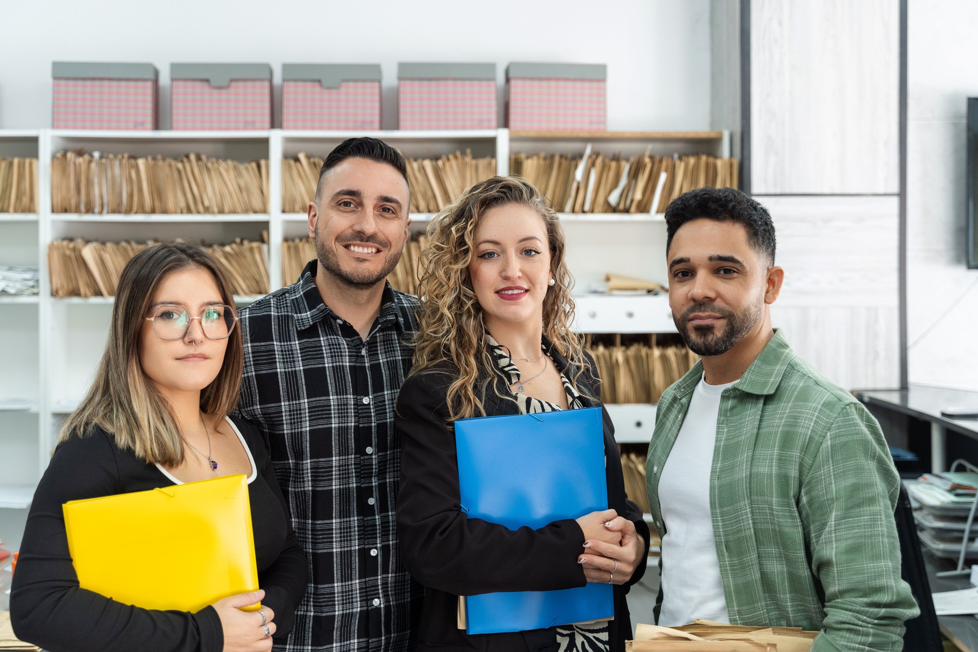 Business team smiling at the office holding folders